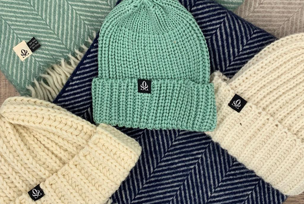 white and green beanies with green and blue blankets
