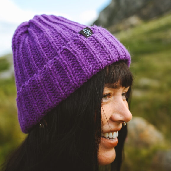 Woman wearing a purple OSS beanie