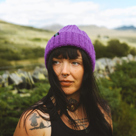 Woman wearing a purple OSS beanie