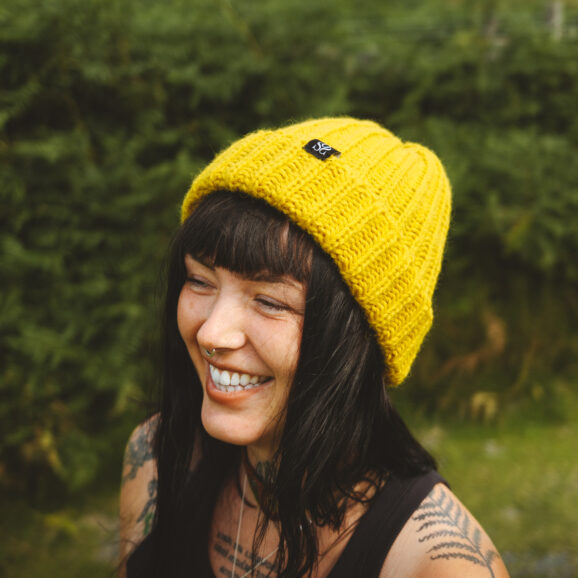 Woman wearing a yellow OSS beanie