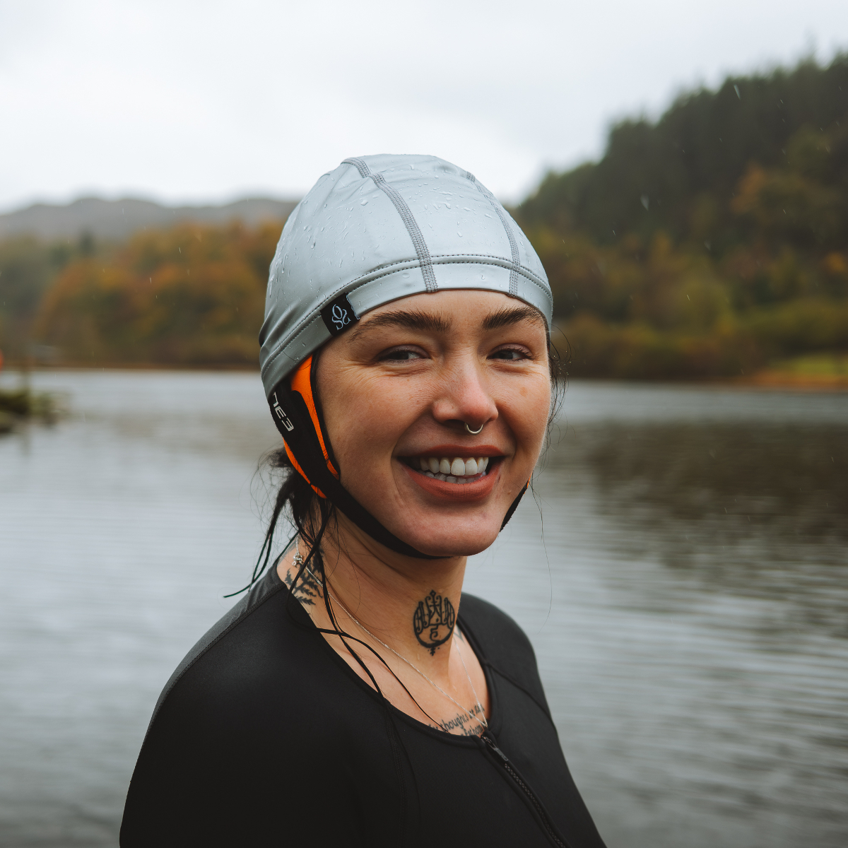 Hollie Harmsworth Woman in a silver swimming cap with a neoprene bonnet underneath