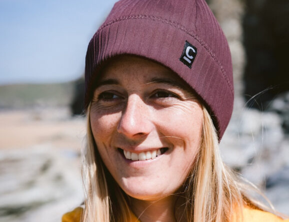 Woman wearing a storm chaser beanie in rust